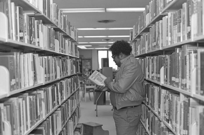 Looking at a Book in the Library
