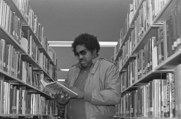 Looking at a Book in the Library
