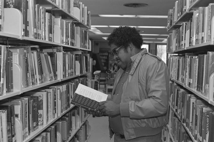 Looking at a Book in the Library
