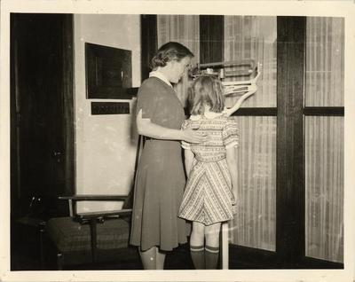 Child being weighed and measured, 1940