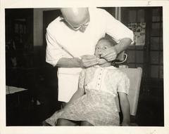 School dentist treating patient at African-American school, 1941