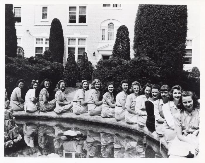 Students Seated Around Garden Fountain