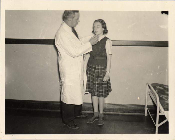 Child given examination by school physician Robert B. Crichton, MD, 1940