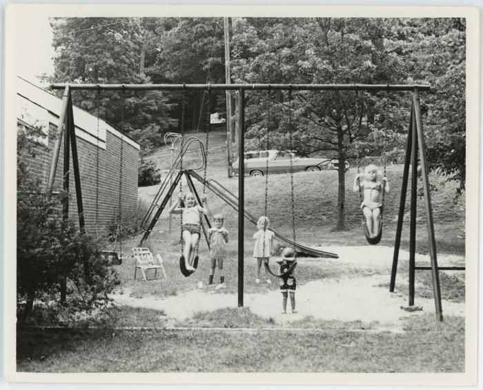 Children Swinging Outside Barcroft Apartments