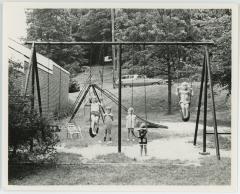 Children Swinging Outside Barcroft Apartments