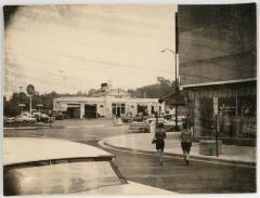 People Crossing the Street Near Gulf Auto