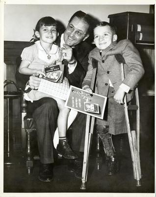 Clinton P. Anderson, Secretary of Agriculture, with Patricia Lee Sisemore and Jimmy Sykes during Easter Seals Sale, 1948
