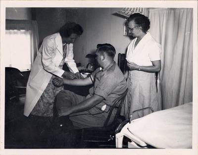 Fireman receiving examination as part of chronic disease program, 1958