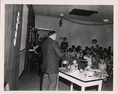 Reverend James L. Robertson at Crippled Children's Christmas Party, 1957
